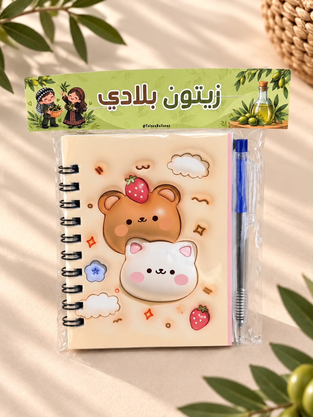 دفتر نوت مع قلم مع تغليف لزيتون